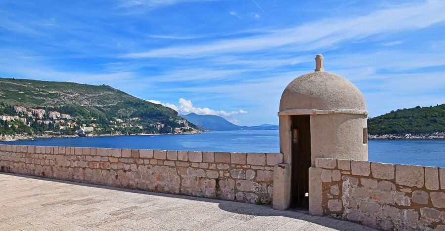 Dubrovnik: City Walls Early Morning or Sunset Walking Tour - Climbing the wall above the terracotta roofs